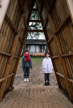 Asian mother and daughter playing in wooden house