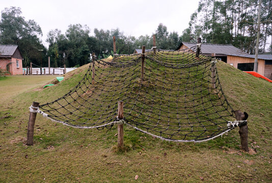 Outdoor climbing net on hillside in nature

