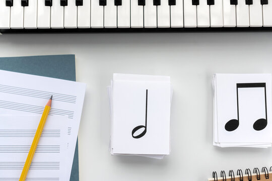 Half note, keyboard, sheet music on table