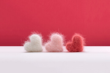 Three fluffy hearts made from colorful yarn