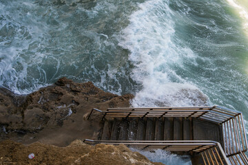waves with stairs on the beach