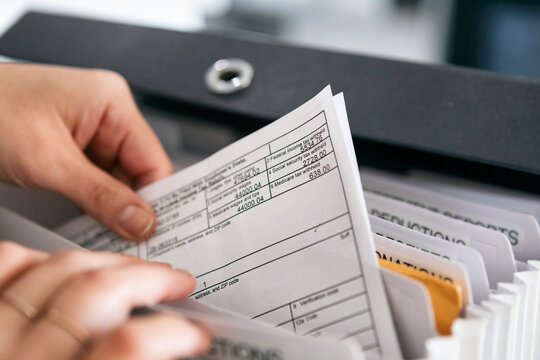 Woman Pulling Out W-2 Tax Form