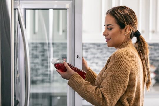 Kitchen: Woman Peers Into Refrigerator