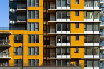 Front side of a apartment building with orange facade