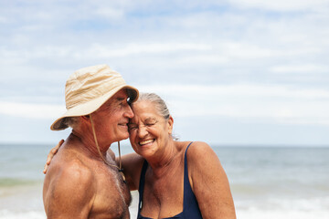 Happy elderly couple having a good time on the beach