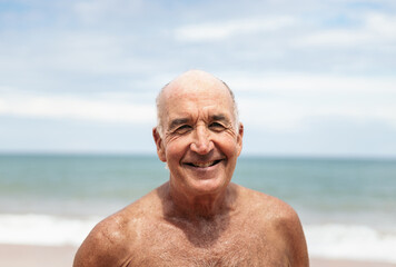 Portrait of a smiling senior man on the beach
