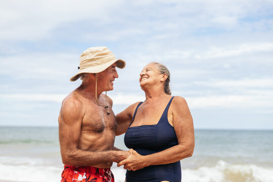 Happy elderly couple having a good time on the beach