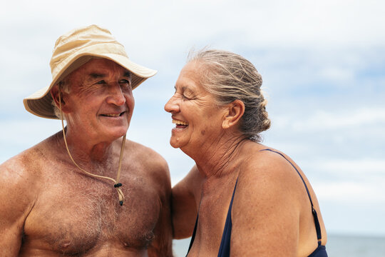 Happy elderly couple having a good time on the beach