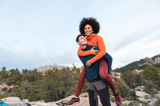 Hiker carrying on back diverse afro hairstyle woman