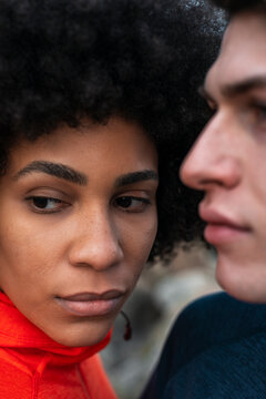 Crop thoughtful diverse couple looking away 