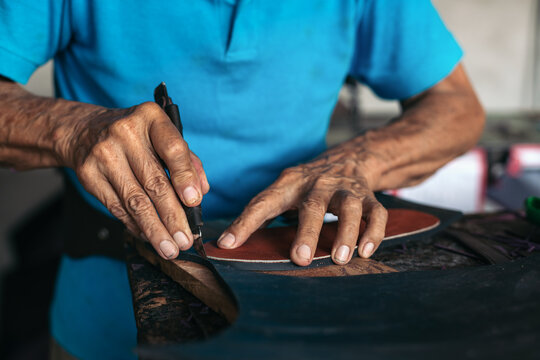 Closeup anonymous shoemaker working