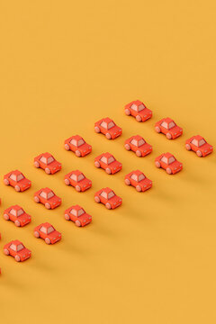 rows of Pink toy car on a yellow background