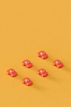 small Pink toy car on a yellow background