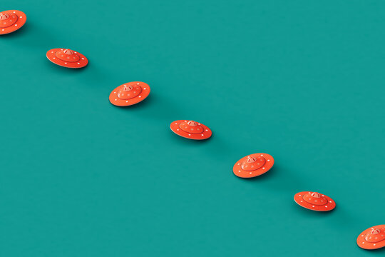 a row of Pink UFOs or UAPs on a blue background. 
