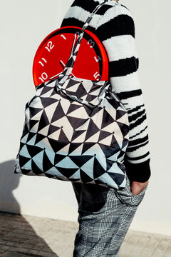 man with a red clock in a shopping bag