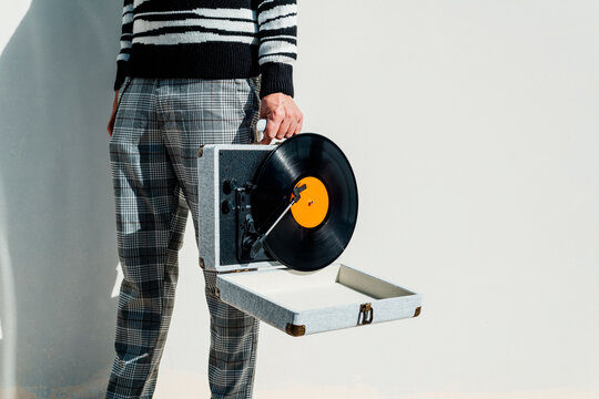 man with a portable turntable in his hand