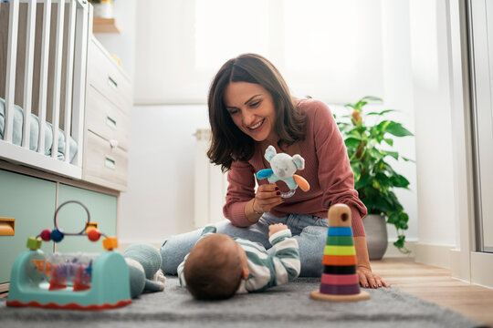 Mother lying with baby on floor