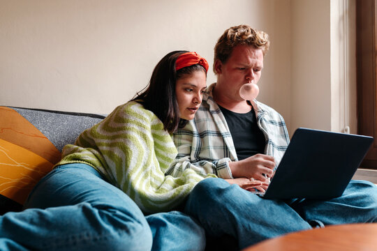 Two young friends using a laptop