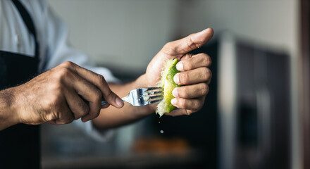 Unrecognizable chef squeezing a lemon