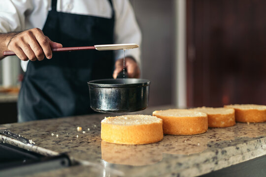 Anonymous pastry chef making a cake