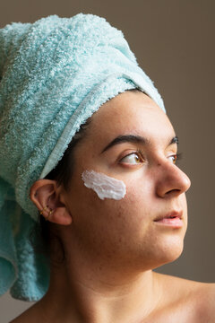 Woman face with cream or nourishing mask