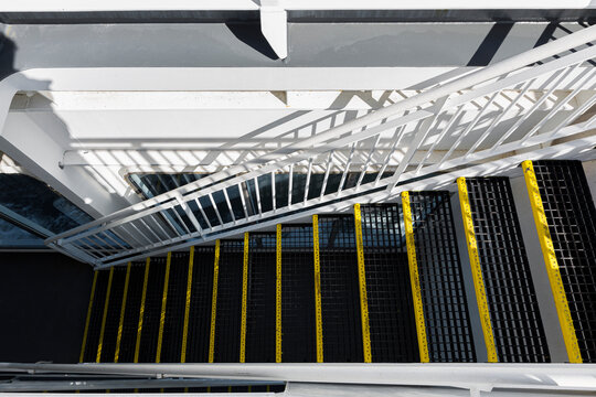 Black stairs with yellow lines in horizontal