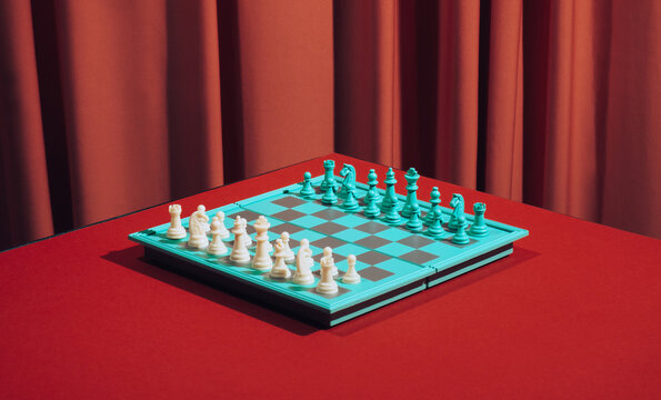 Still life chess board on red background.
