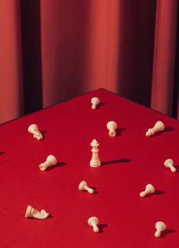 Still life chess board on red background.