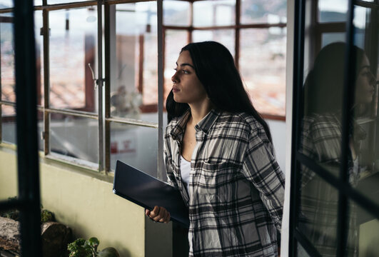 Young woman walking up the stairs with laptop