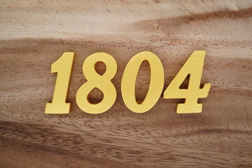 Golden Arabic numerals on a real brown and white wooden floor number 1804