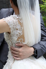 the groom's hand hugs the bride