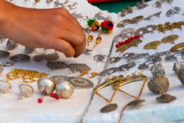 Blurred image of various shapes and shades of earrings , handicrafts on display during the Handicraft Fair in Kolkata , Calcutta, West Bengal, India. It is the biggest handicrafts fair in Asia.