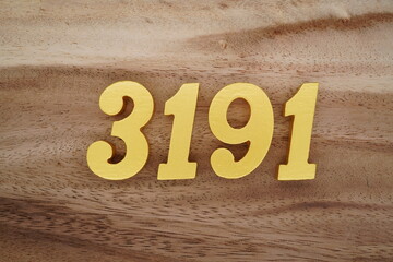 Golden Arabic numerals on a real brown and white wooden floor number 3191