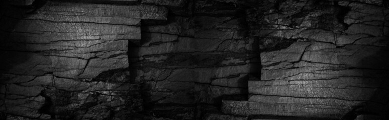 Black white grunge background. Old cracked damaged destroyed stone wall. Close-up. Hole, entrance. Backdrop with space for design. Wide banner. Panoramic. Fantasy, horror concept.