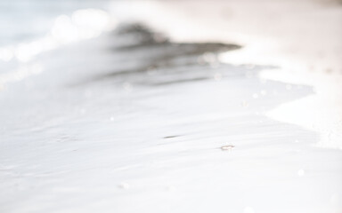 Closeup image of the sea and white sand beach