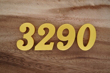 Golden Arabic numerals on a real brown and white wooden floor number 3290