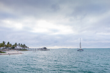 Catamaran in the bay, storm clouds in background