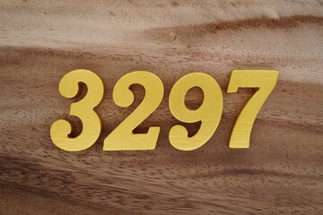Golden Arabic numerals on a real brown and white wooden floor number 3297