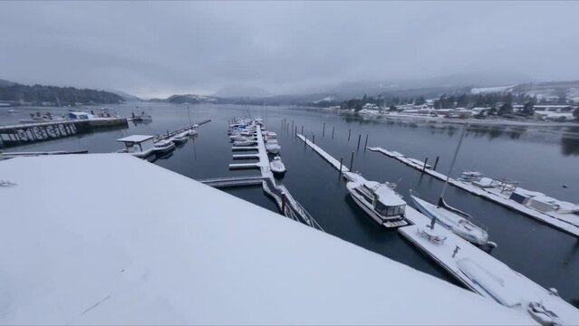 Overcast Winter Skies on a Snow-Covered Marina in Sechelt Inlet British Columbia Canada - Fast Moving Forward Panning Drone Shot 1080p 60 frames per second