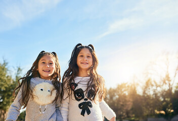 Here together having fun in the sun. Cropped shot of two adorable little girls outdoors.