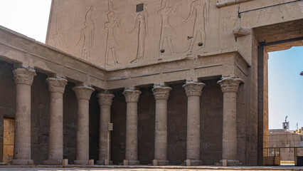 The inner hall of the ancient temple of Horus in Edfu. Columns with elegant capitals, a wall with...