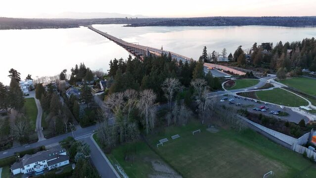 Cinematic 4K aerial drone sunset shot of the 520 Bridge View Park with Medina's expensive homes, views of Laurelhurst, Lake Washington's mansions, luxury homes, villas