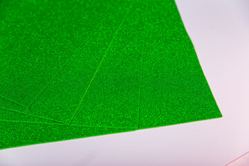Green Sheets of cardboard with sparkles on a white background.