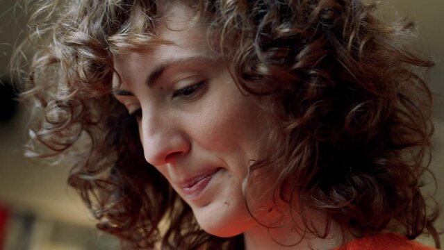 Beautiful European Young Woman Face With Curly Hair Reading, Close Up