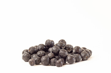 a bunch of black rowan berries on a white background