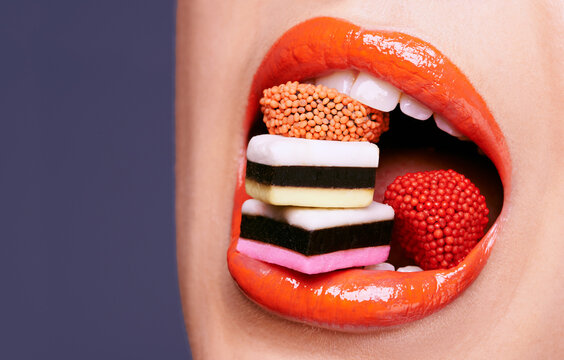 Shes A Candy Queen. Cropped Shot Of A Beautiful Young Woman Eating Liquorice Sweets.