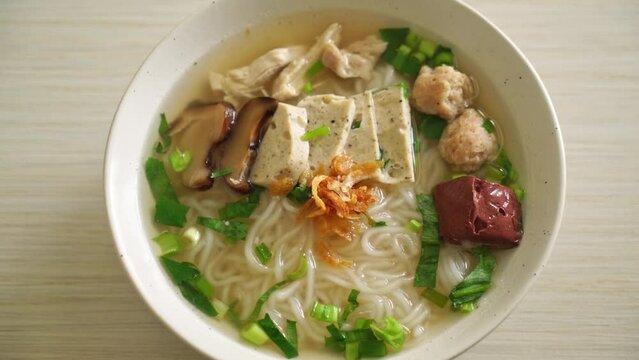 Vietnamese Rice Noodles Soup with Vietnamese Sausage served vegetables and crispy onion - Asian food style