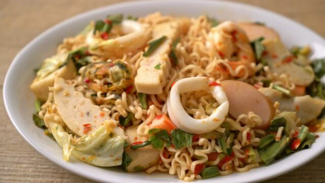 Instant noodle spicy salad with mixed meats - Asian food style