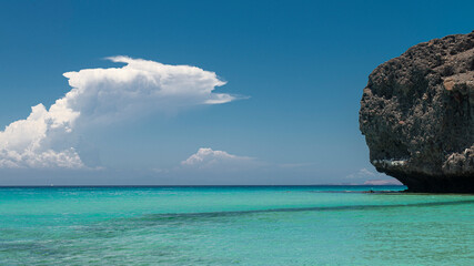 Landscape, seascape of a beautiful Mexican beach, with mountains clouds in the background, a blue sky and turquoise water. concept of vacations and nature, horizontal view