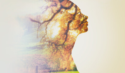 In touch with nature. Composite image of nature superimposed on a womans profile. - Powered by Adobe